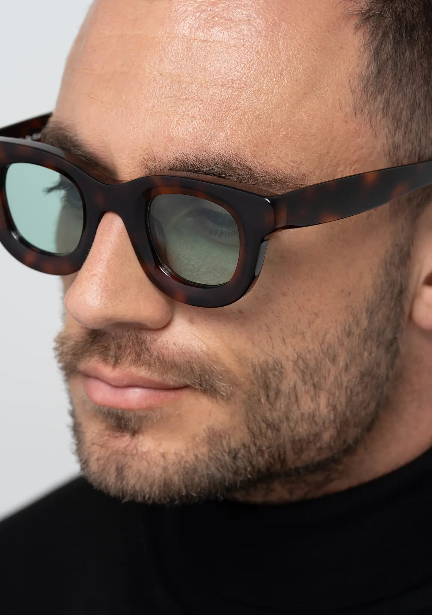 mens sunglasses Bo Bo Noir Triboulet panto round in tortoise acetate with light blue nylon lenses, man wearing, profile view.