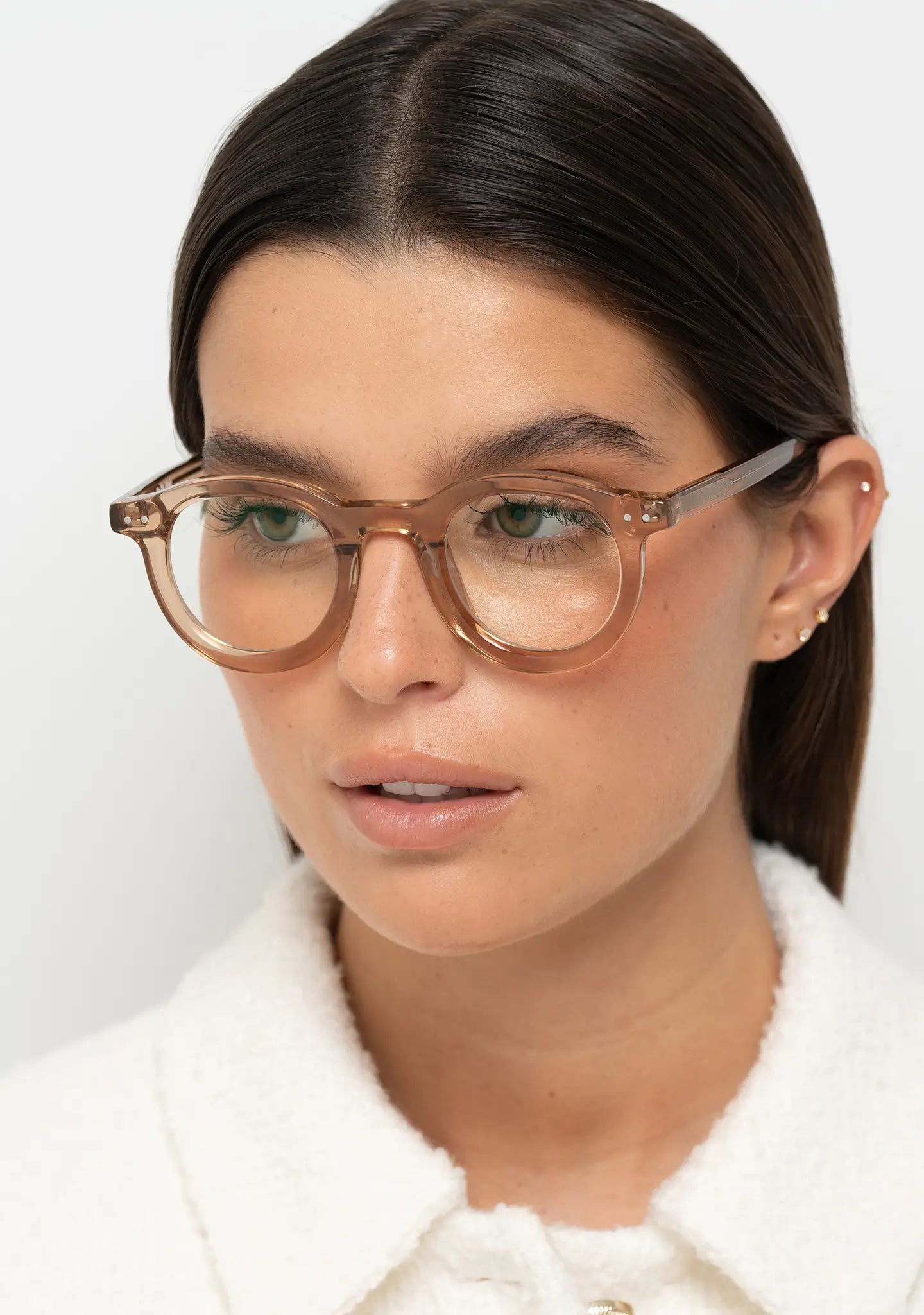 womens blue light blocking glasses Bo Bo Noir William round in crystal peach acetate with CR-39 green tint lenses, woman wearing, side view.