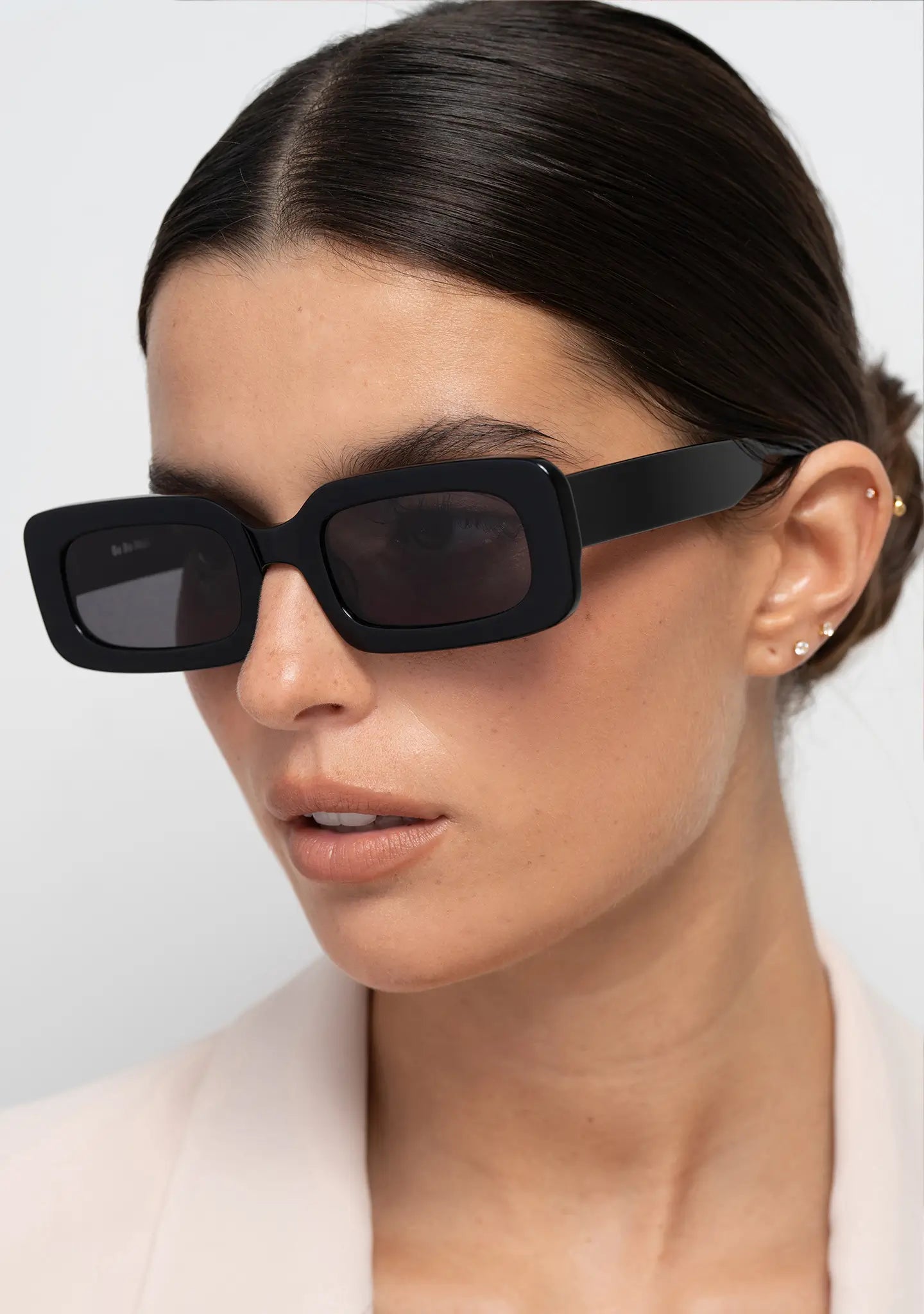 Bo Bo Noir Jane shiny black rectangular womens sunglasses, woman wearing, side view.
