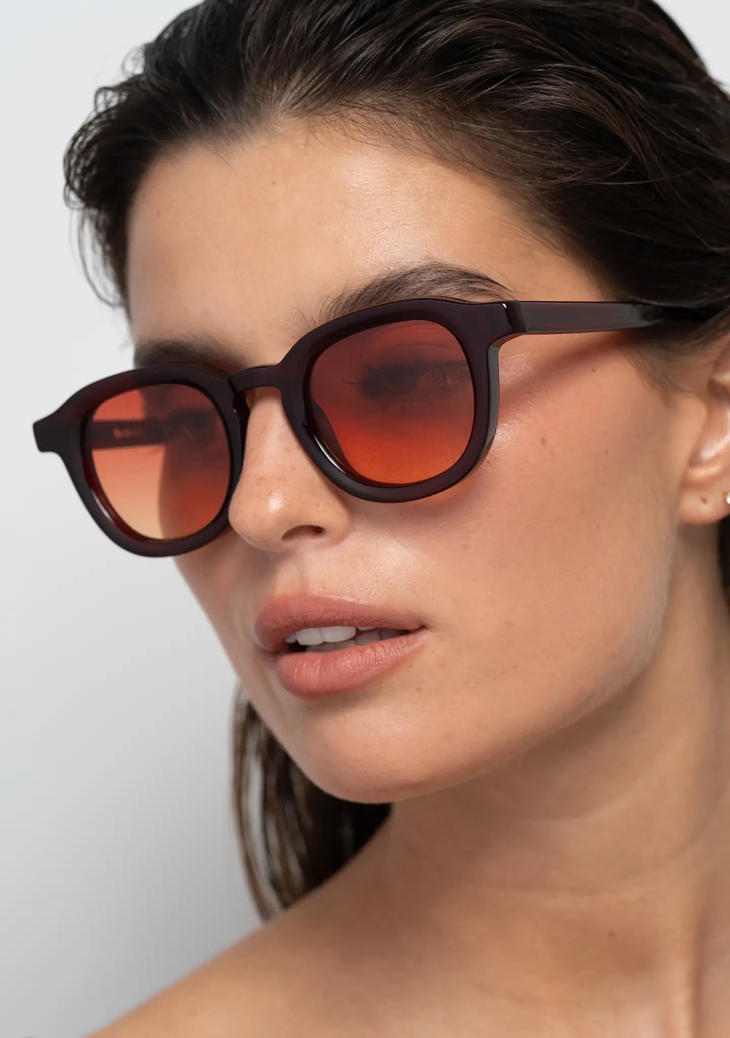 womens sunglasses Bo Bo Noir Narr panto round in deep burgundy acetate with gradient sunset red nylon lenses, woman wearing, side view.