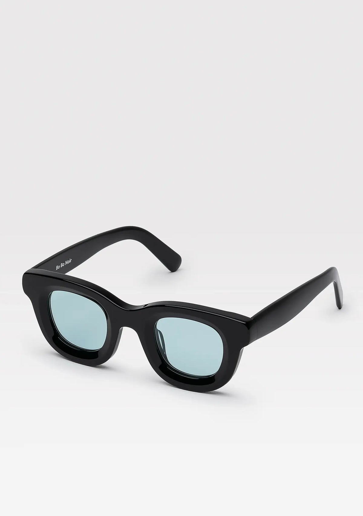 Triboulet panto sunglasses with shiny black acetate frame and light blue lenses, angled view