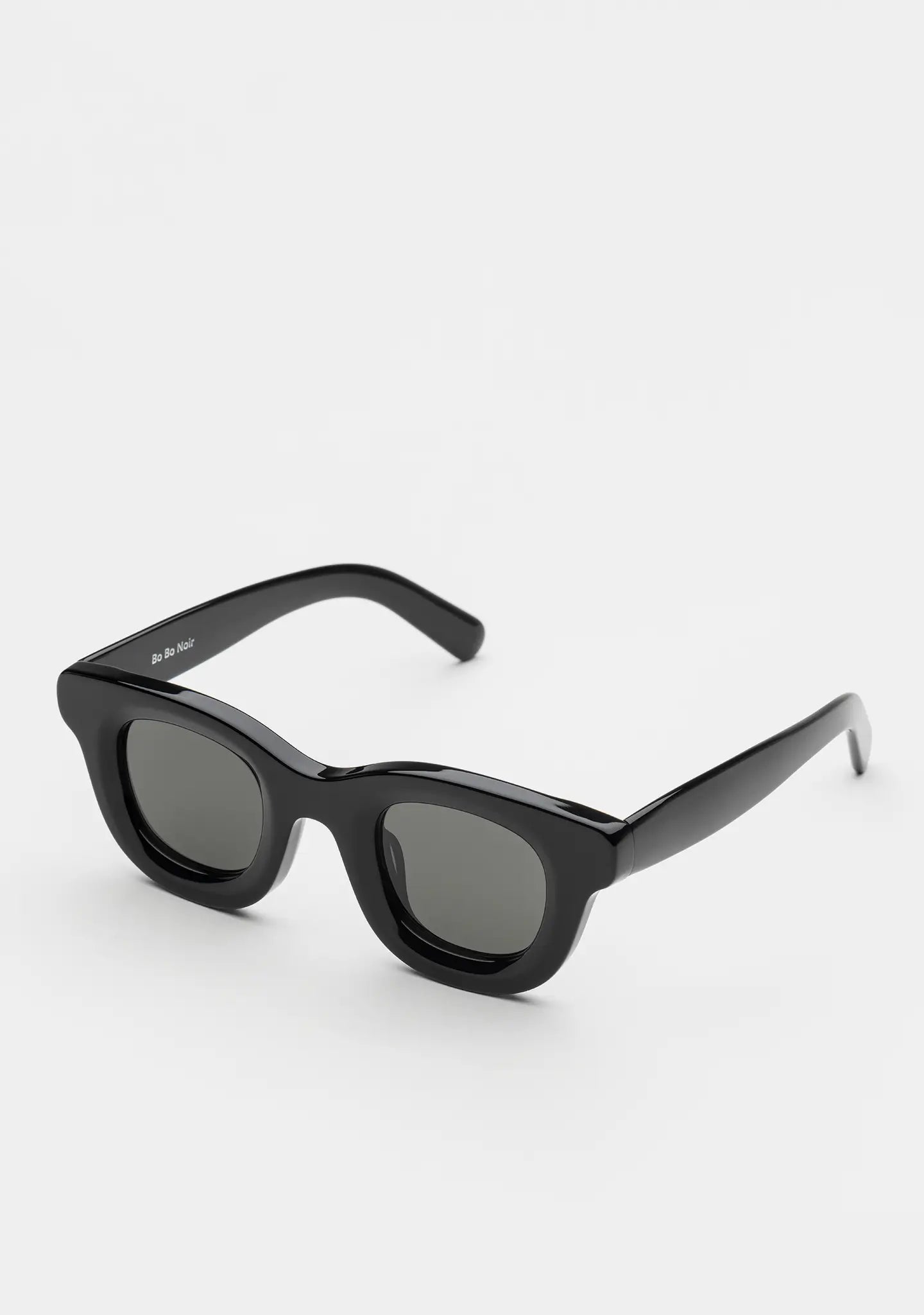 Bo Bo Noir Triboulet panto round sunglasses in shiny black acetate with gray nylon lenses, angled view.