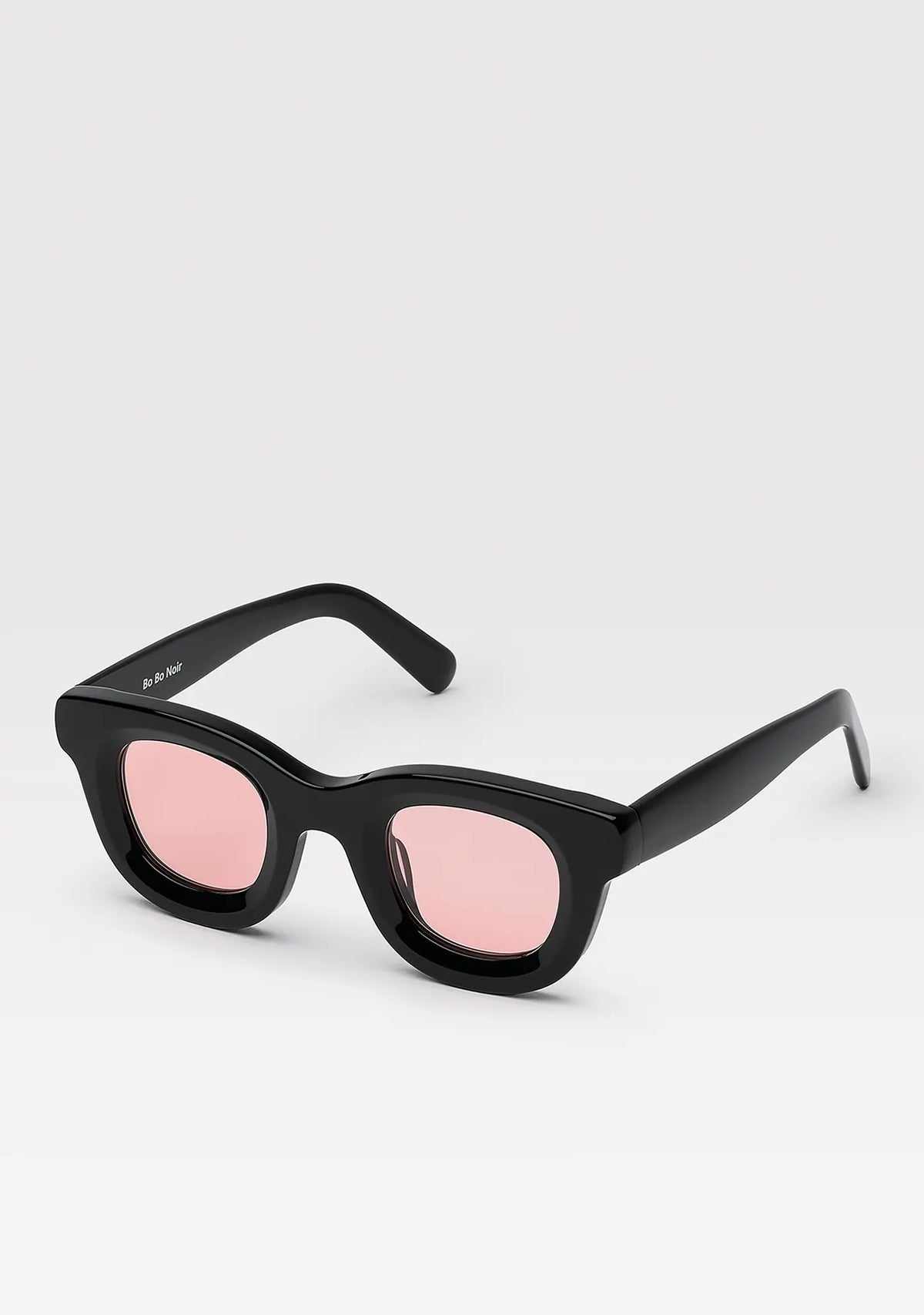 Triboulet panto sunglasses with shiny black acetate frame and pink lenses, angled view
