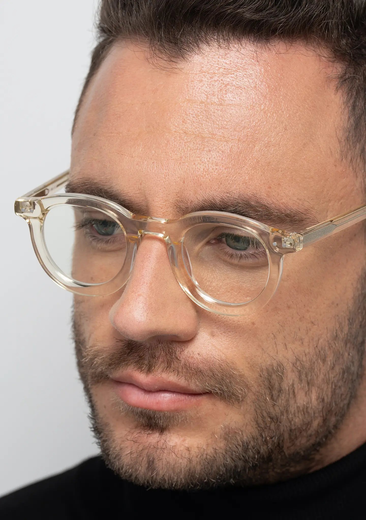 mens William crystal yellow round blue light blocking glasses worn by a man close up