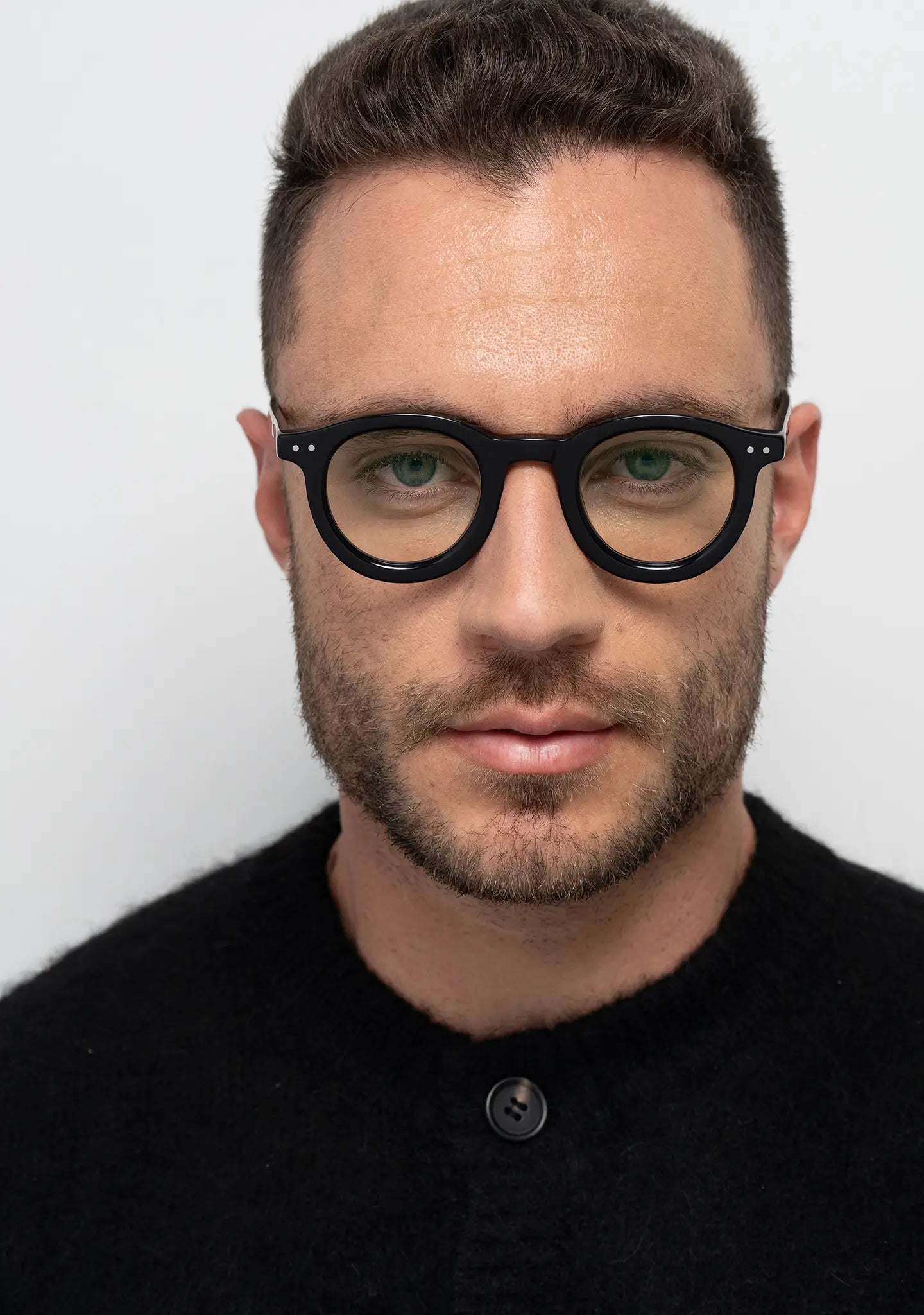 mens William shiny black round blue light blocking glasses worn by a man front view