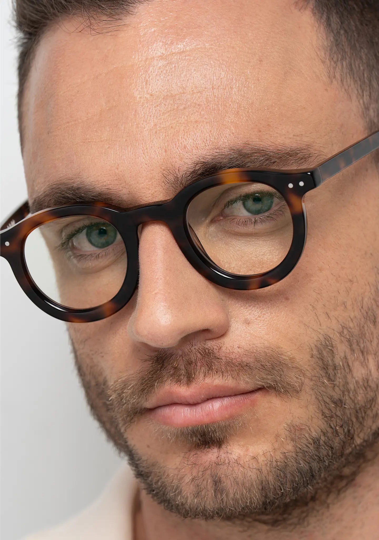 mens William tortoise blue light blocking glasses worn by a man close up