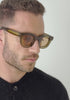 mens sunglasses Bo Bo Noir Triboulet olive panto round in acetate, man wearing, slow motion head turn side to front.