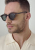 mens William tortoise round sunglasses worn by a man